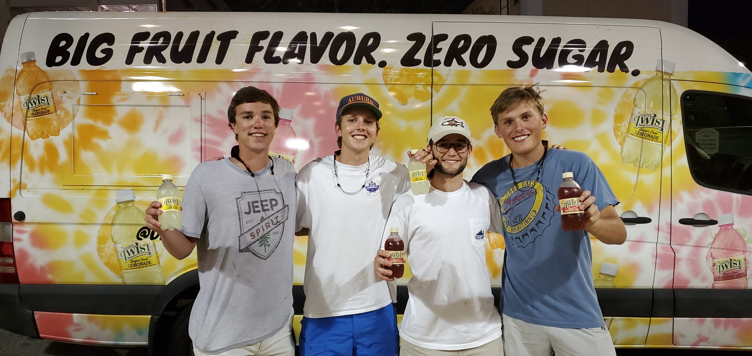 People posing in front of a flavored drinks snack truck