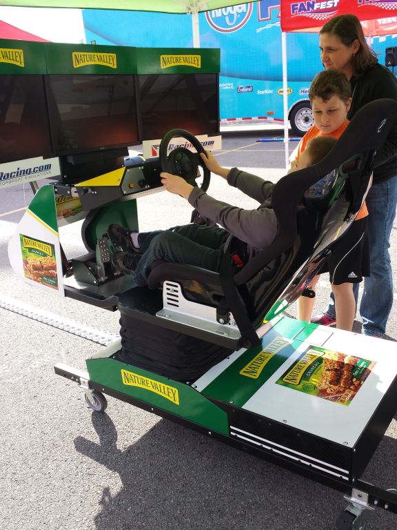 Girl playing with a race car simulator