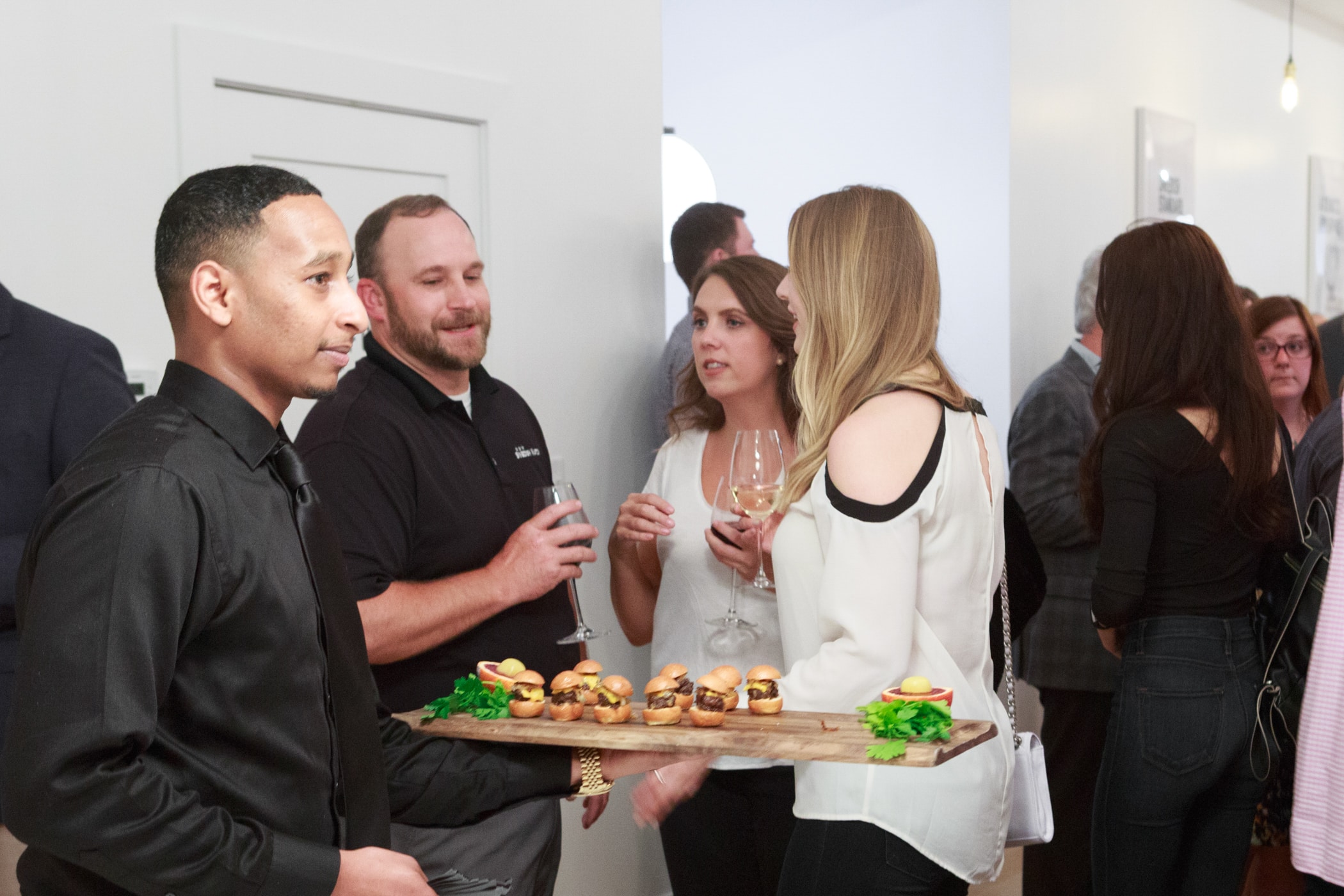 People chatting with drinks in their hands