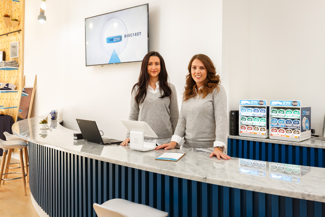 Two women standing at the till counter