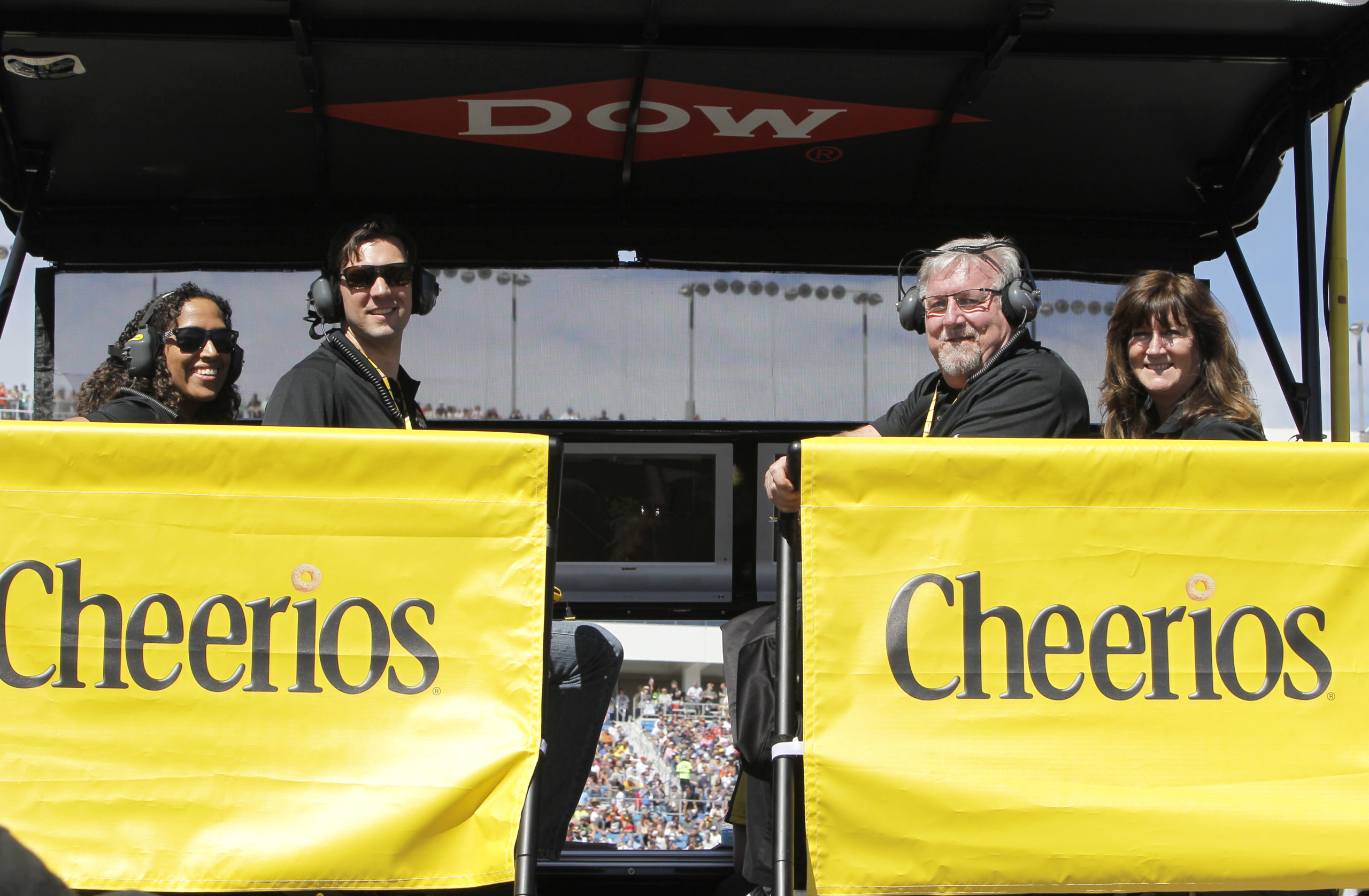 Four people sitting in a Cheerios promobile