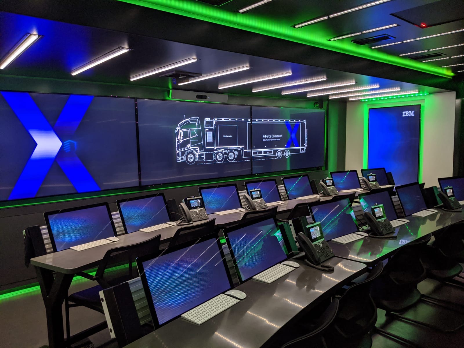 IBM command center with laptops and big screens