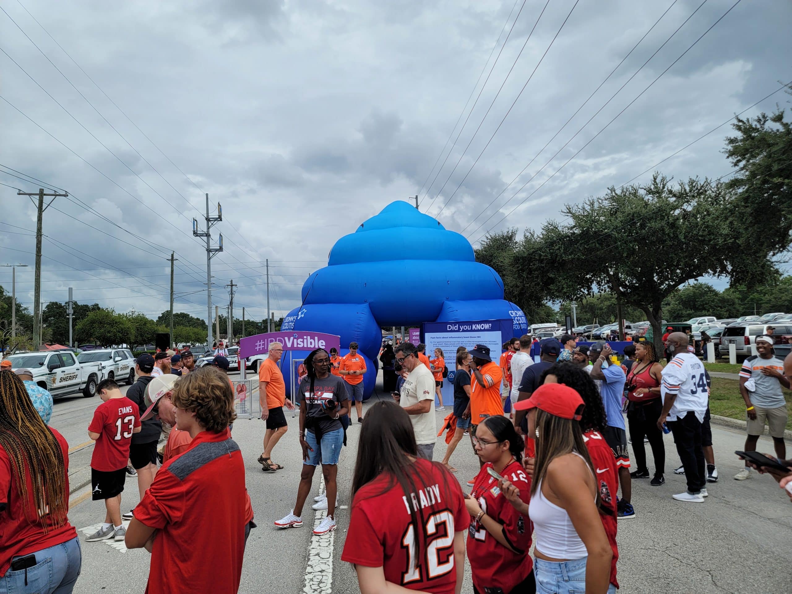 People gathered near a blue tent