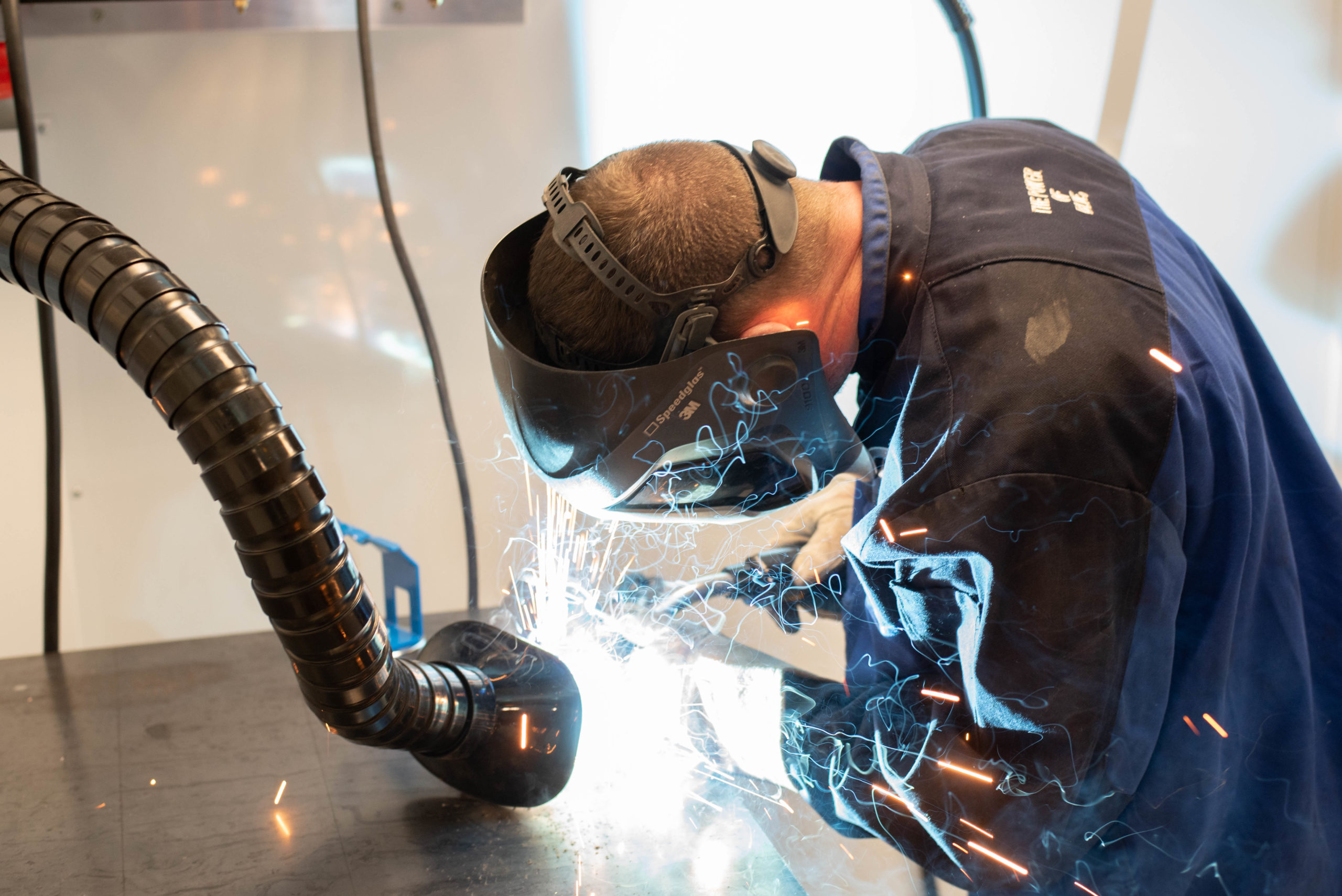 A man welding in First Institute mobile welding lab