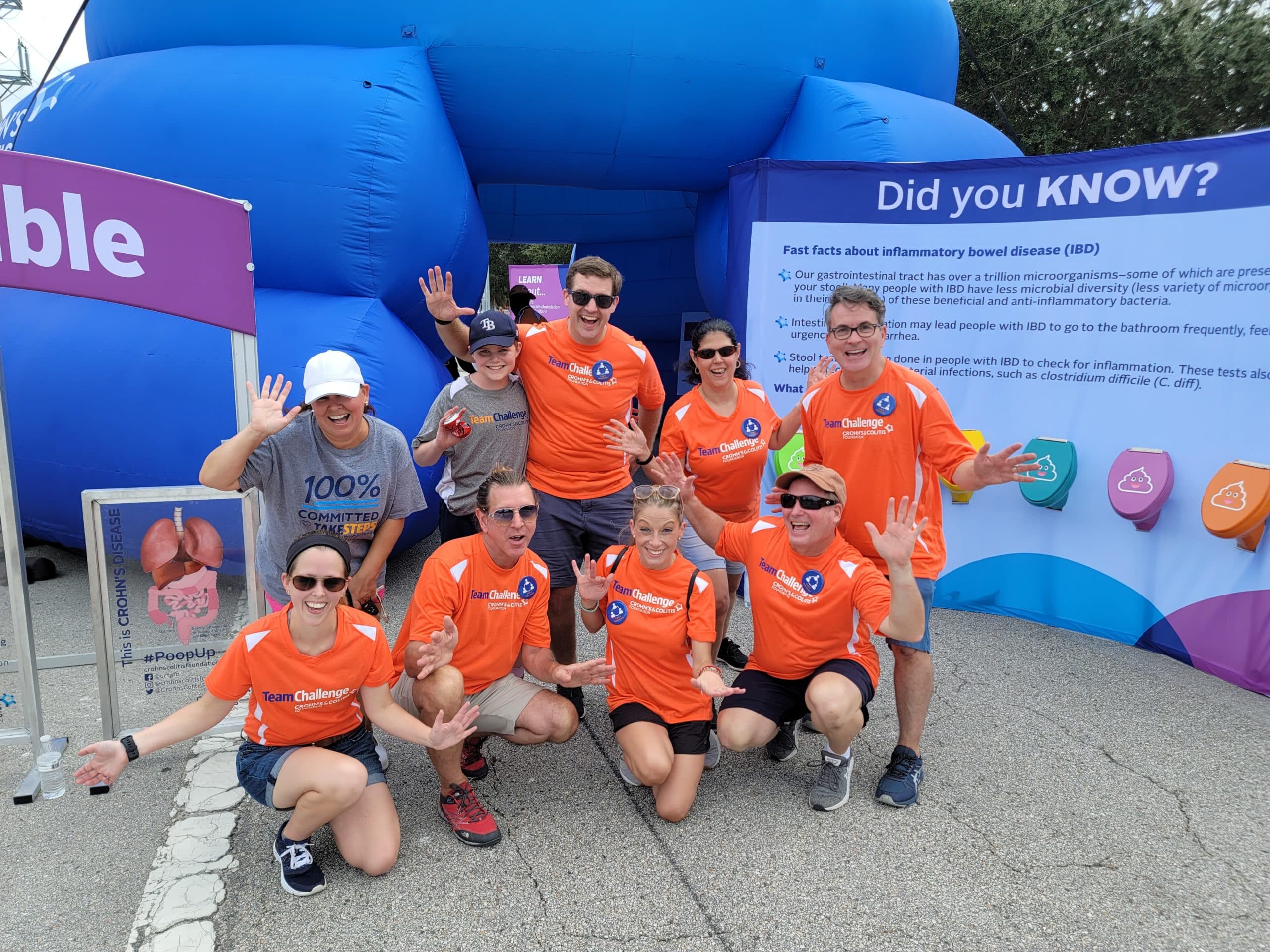 People posing in orange tee shirts