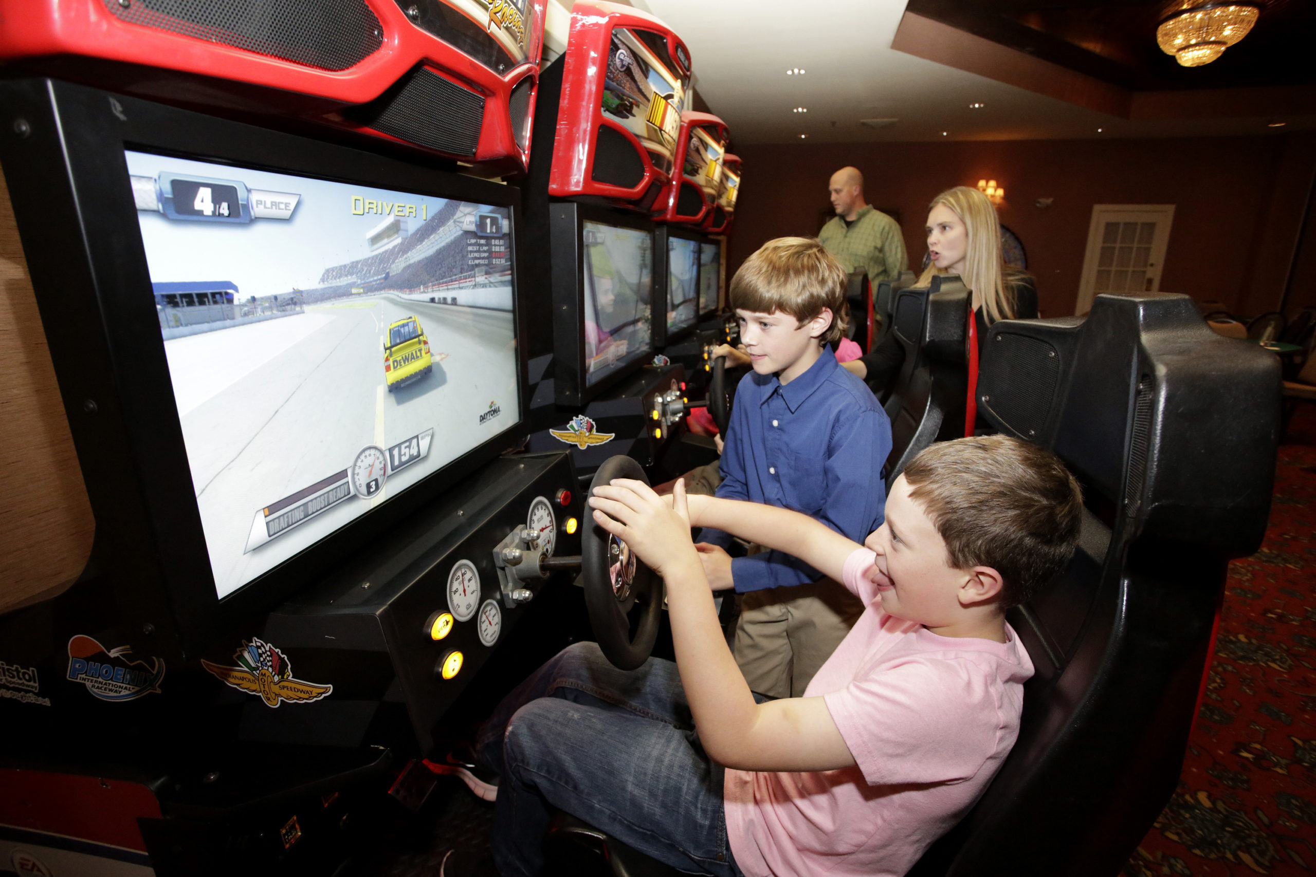 kids playing on race car simulators