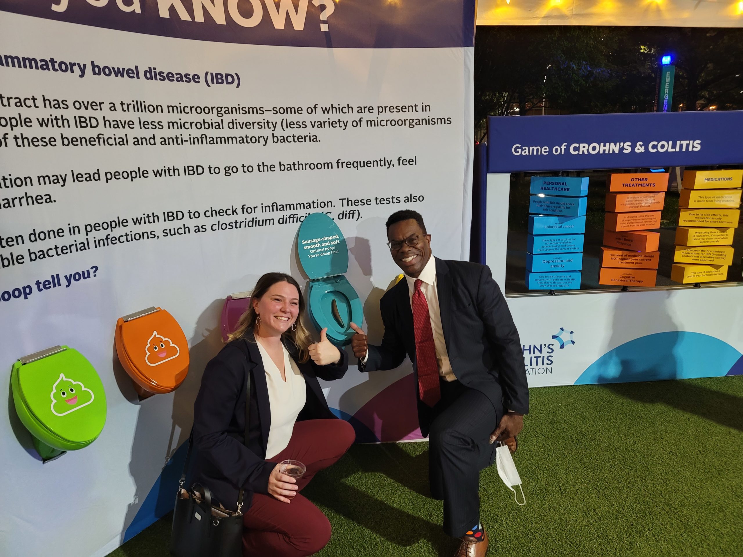Two people posing with an info wall