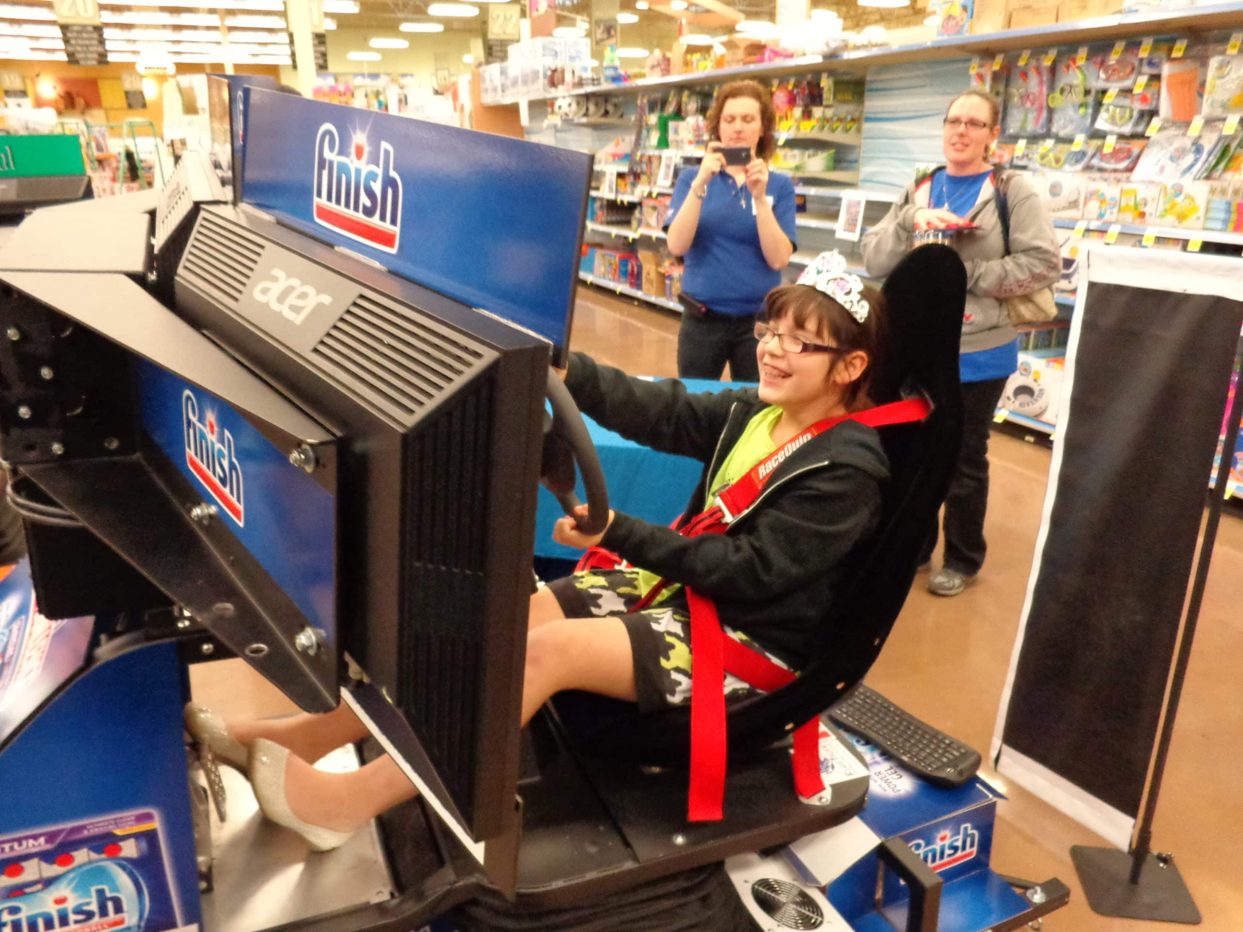 Woman playing a car simulator at Kroger