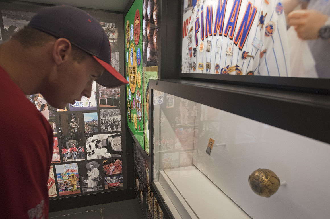 A man looking at the displays in MLB mobile museum trailer