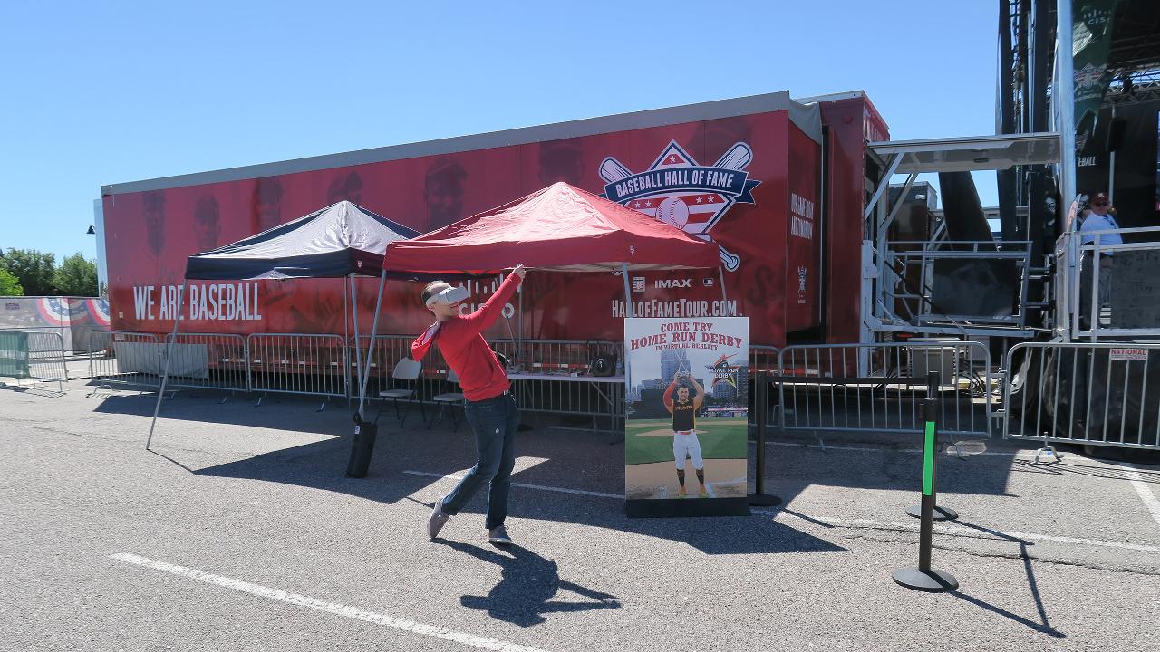 A man wearing a MLB VR set outside of a red trailer