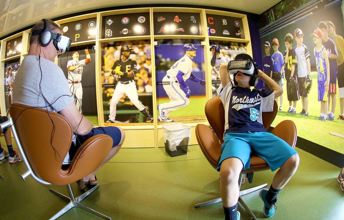 Two people trying on the MLB VR