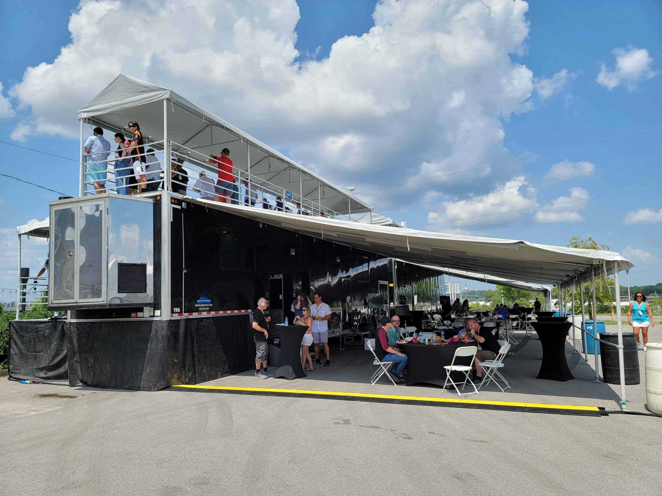 People on promobile double decks watching the tracks at Music City Grand Prix