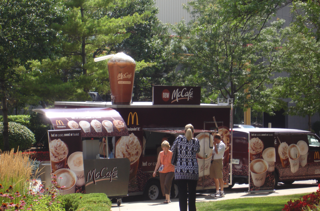 People in front of BMG McCafe Mobile Kitchens