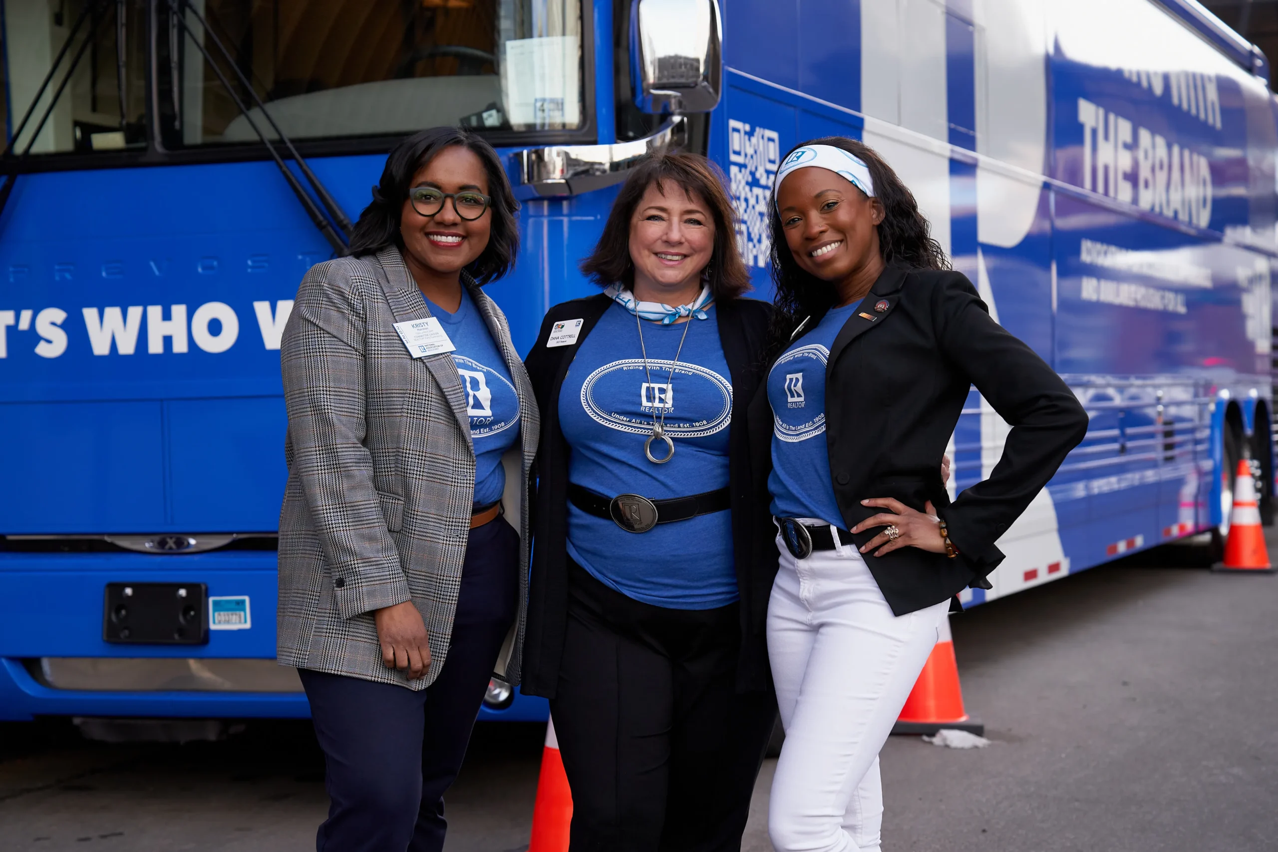 Three women posing in front of a BMG designed truck for the National Association of REALTORS®